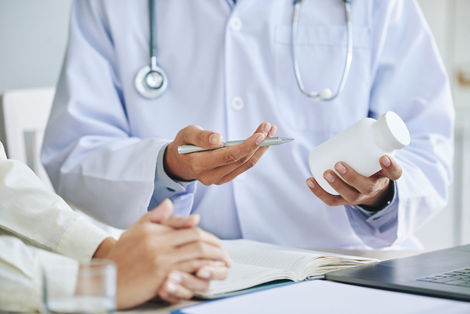 unrecognizable-female-doctor-recommending-medication-patient